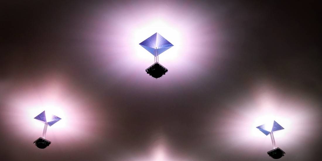 Three ceiling light fixtures, switched on